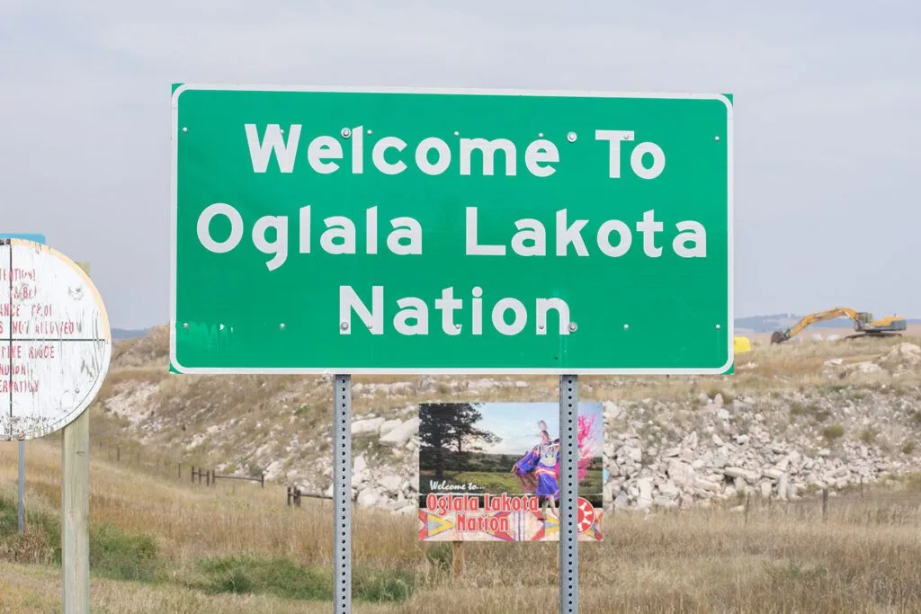 A sign welcomes visitors to the Oglala Lakota Nation at the Pine Ridge Indian Reservation.