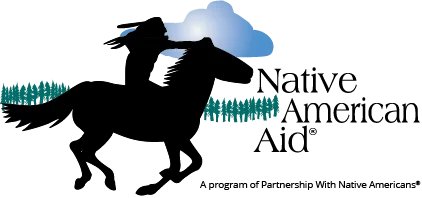 Logo for the Native American Aid that shows a silhouette of a Native American warrior holding a spear with mountains and pine trees in the background, symbolizing strength and heritage under a blue sky.